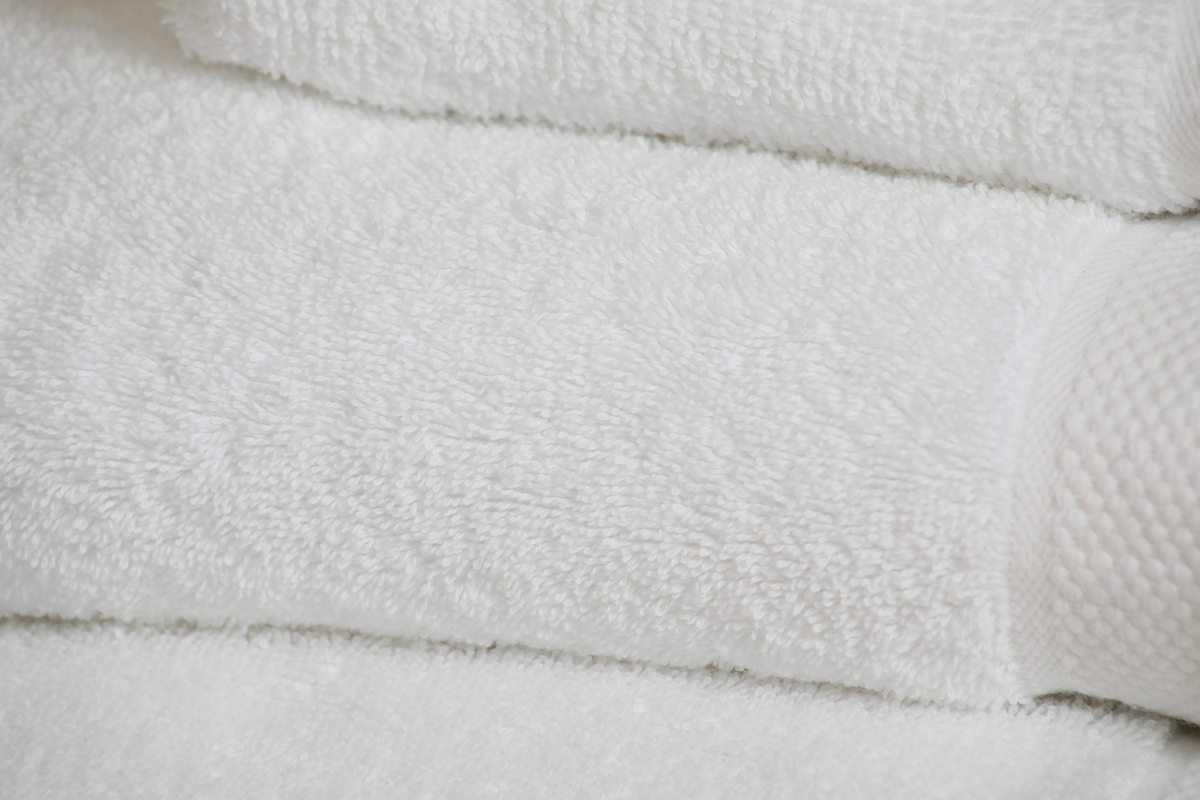 Close-up of KSE Excellence Collection Hotel Hand Towels, neatly folded to highlight their soft, fluffy premium cotton texture.