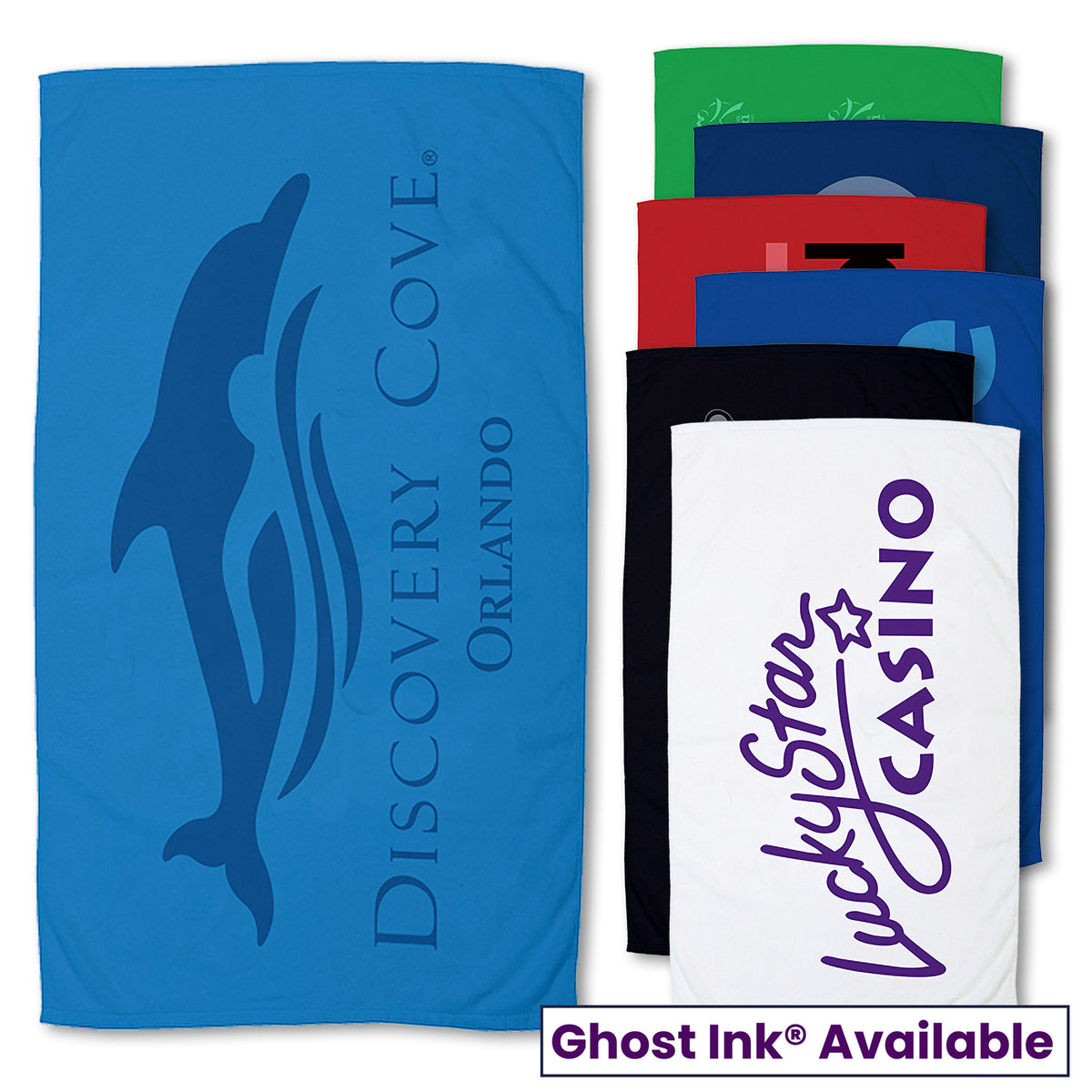 A blue Small Beach Towel by Pro Towels featuring a dolphin and Discovery Cove Orlando, displayed beside five stacked towels (green, red, black, navy, white). The white towel shows Lucky Star Casino. Text: Ghost Ink Available.