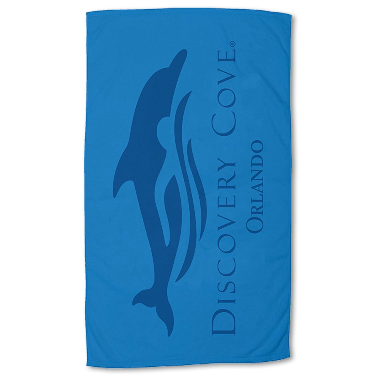 The Pro Towels Small Beach Towel showcases a large dark blue dolphin silhouette with wave accents and Discovery Cove Orlando printed vertically next to the design.