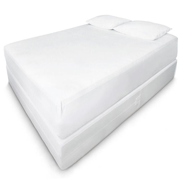 A neatly made bed featuring the Ganesh Mills Oxford Box Spring Encasement Cover with Zipper, a white mattress, and two white pillows on a plain white background.