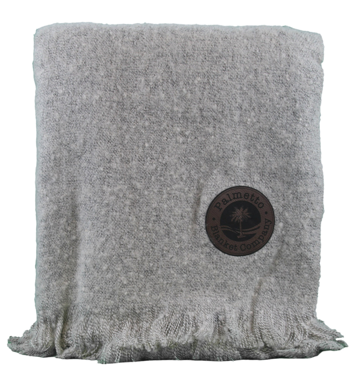 A folded, light gray Earthly Comfort Throw EnviroFibr by Pro Towels features fringe and a round brown patch with a palm tree logo and “Palmetto Blanket Company” text. Made from sustainable materials.