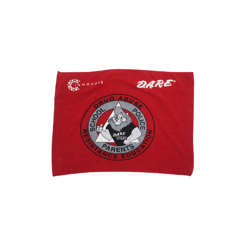 The Rally Towel by Pro Towels is a red cloth towel featuring the D.A.R.E. logo with a cartoon lion in a black shirt and text reading “School Drug Abuse Police Resistance Education Parents”—ideal for bulk promos.