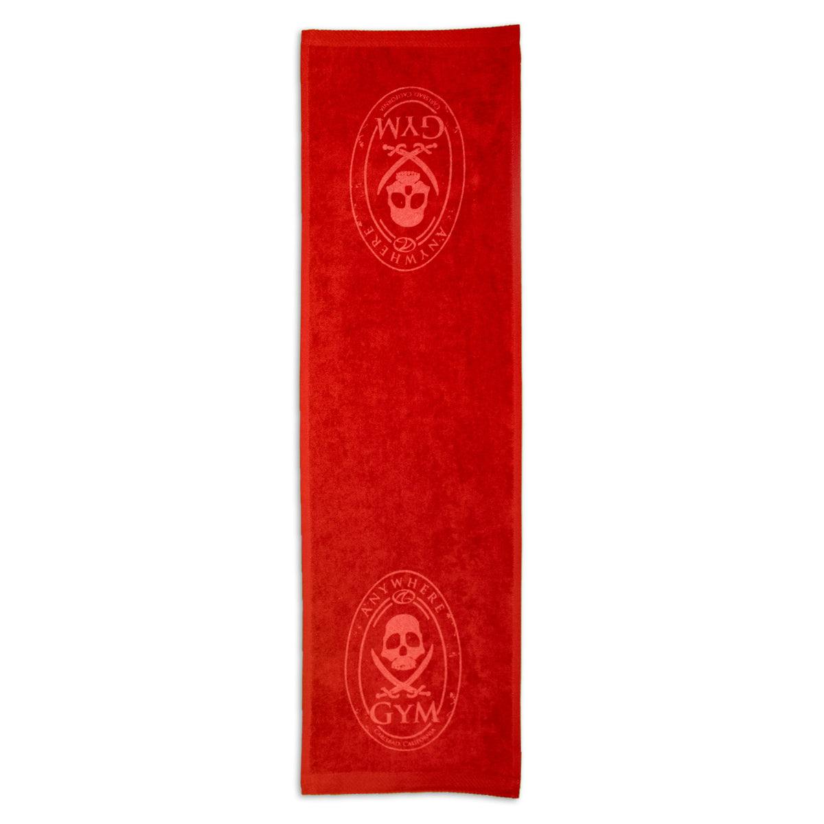 The Pro Towels Fitness Towel is a long, rectangular red promo workout towel with an embossed skull and crossbones in an oval at each end, plus the text ANY WHERE GYM.