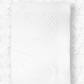 The 1Concier Guest Spa-terry Diamante bath mat is a soft, white rectangular cotton mat with a diamond-quilted center—perfect for adding comfort and style to your marble tile floor.