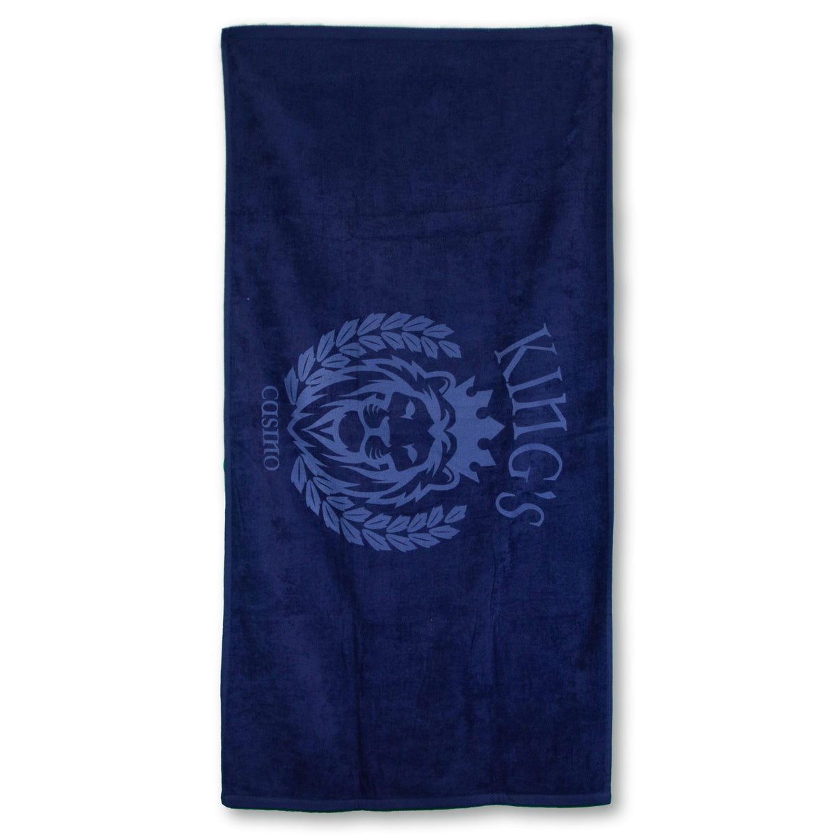 The Beach Towel - Jewel Collection by Pro Towels is a dark blue rectangular towel with a lions head in a laurel wreath, crowned above, and KINGS CASINO in custom embroidery—perfect for wholesale orders.
