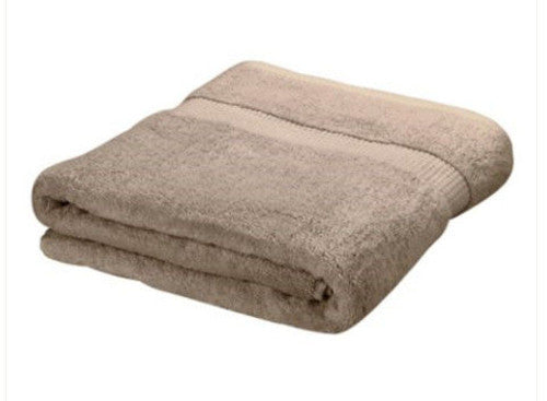 The Oxford Lounge Cover Towel by Ganesh Mills in white/beige features soft cotton terry with a textured horizontal band, shown neatly folded on a plain white background.