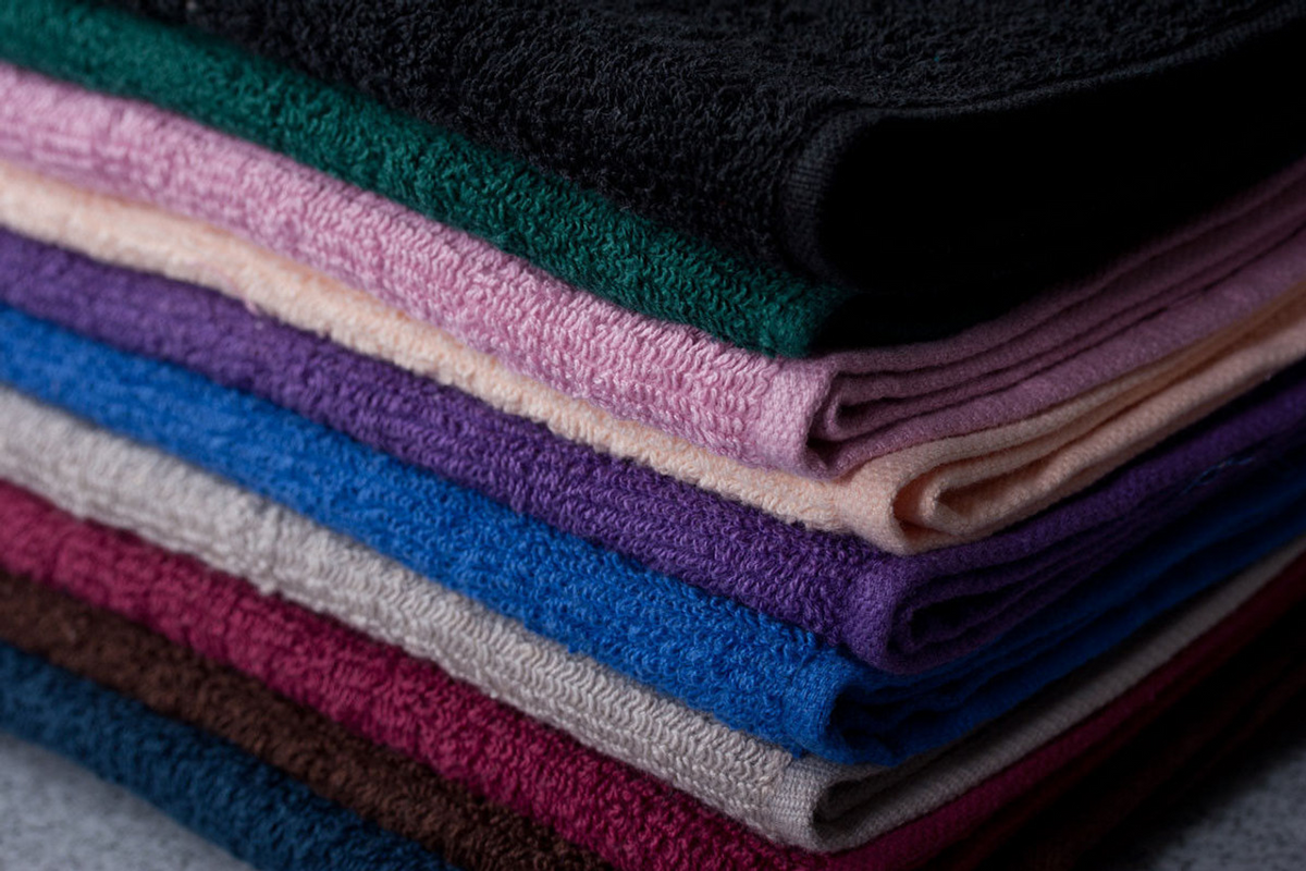 The Oxford Salon And Spa Towel - Colored by Ganesh Mills is a ringspun cotton towel available in black, green, pink, purple, beige, blue, burgundy, and brown—ideal for salon or spa use.