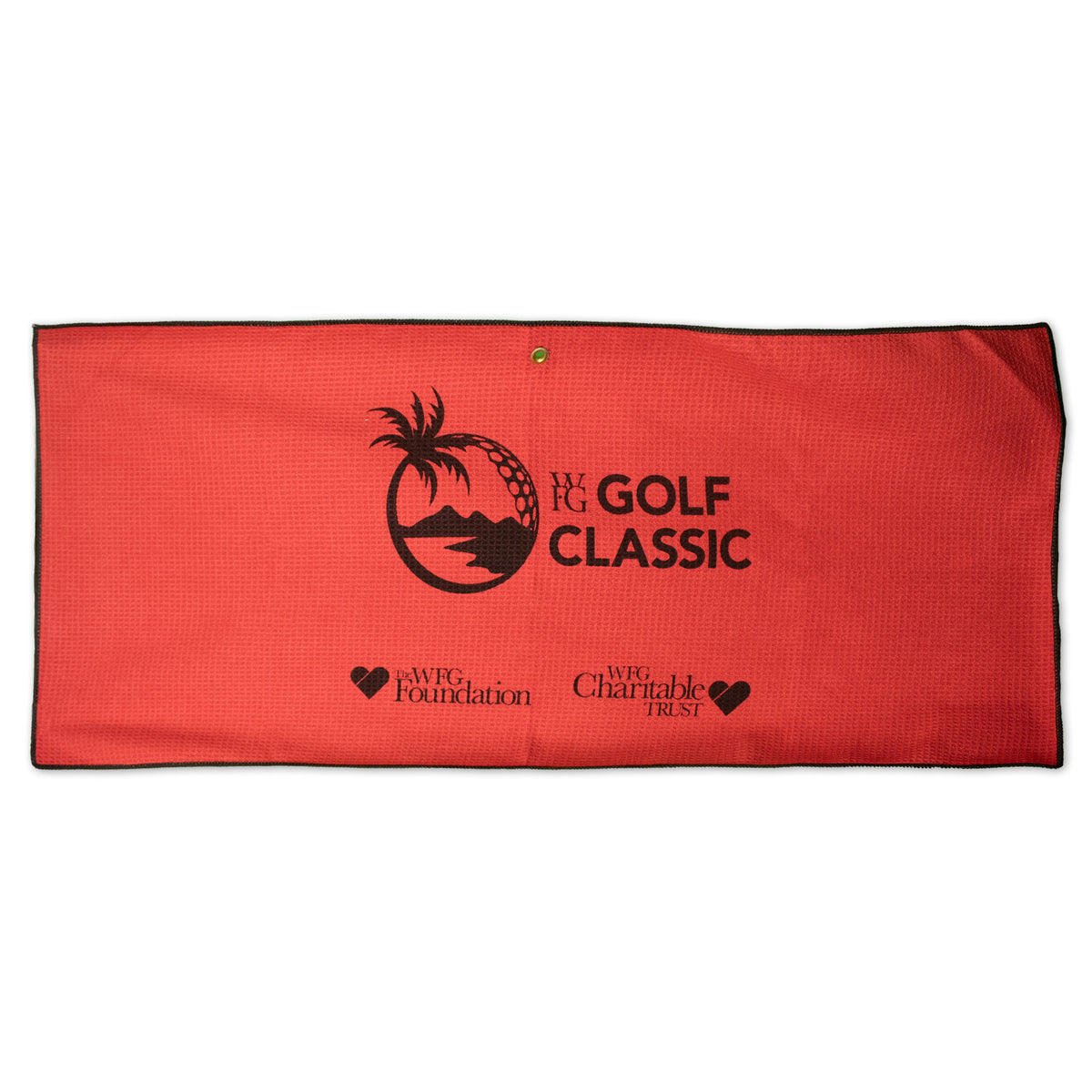 The Pro Towels Microfiber Waffle Caddy Towel is a red custom golf towel with black trim, palm tree and golf ball logo, WFG Golf Classic text, plus WFG Foundation and WFG Charitable Trust logos with heart icons.