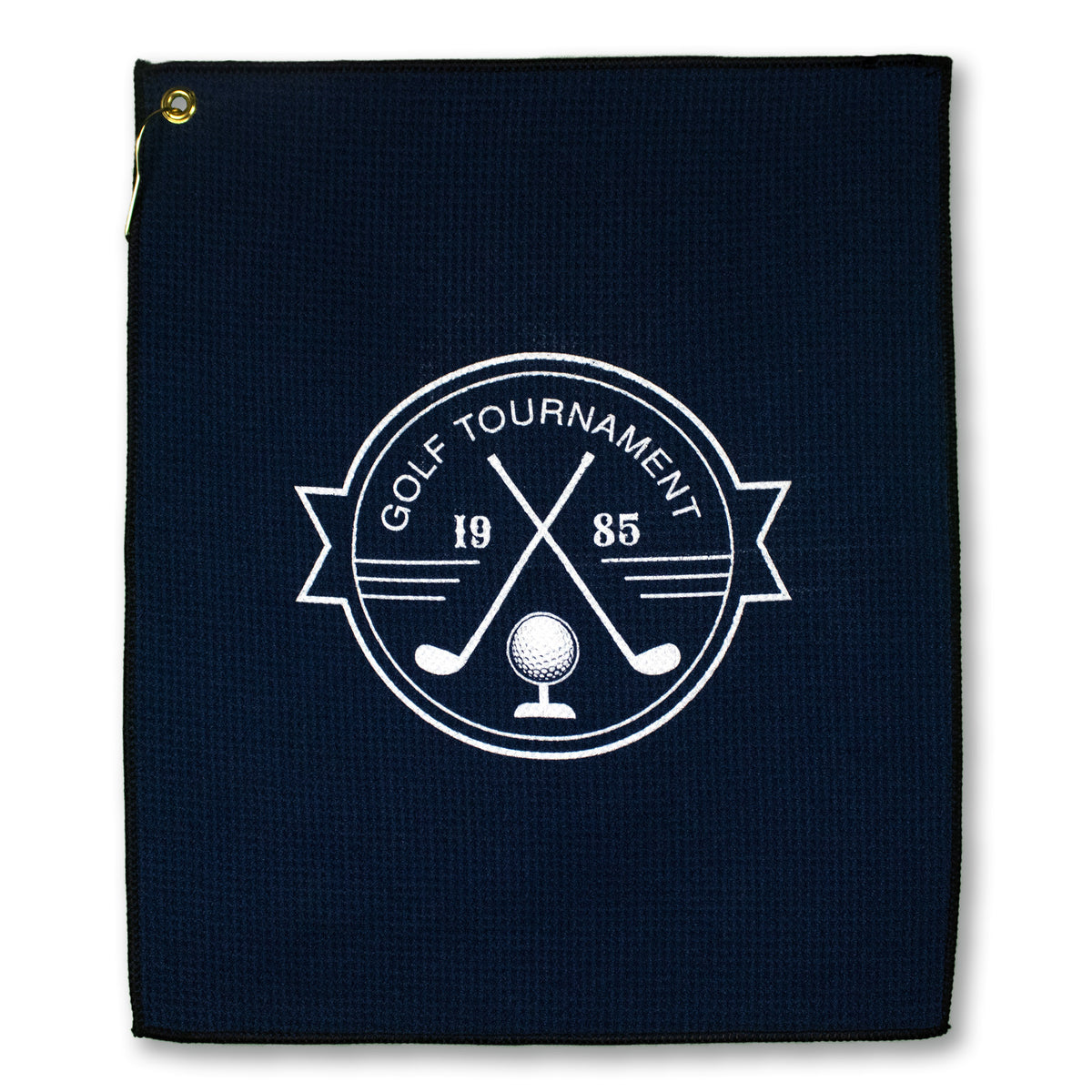 The Pro Towels Microfiber Waffle Small Golf Towel in dark blue features a white emblem with two crossed golf clubs, a golf ball on a tee, "Golf Tournament 1985," and comes with a metal grommet in the top left corner.