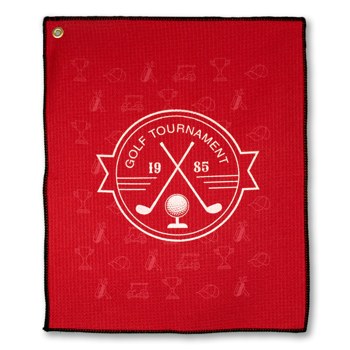 The Pro Towels Microfiber Waffle Small Golf Towel is red with a black border, featuring a white “Golf Tournament 1985” logo with crossed golf clubs, a golf ball, and banner, plus subtle golf icons woven into the microfiber background.
