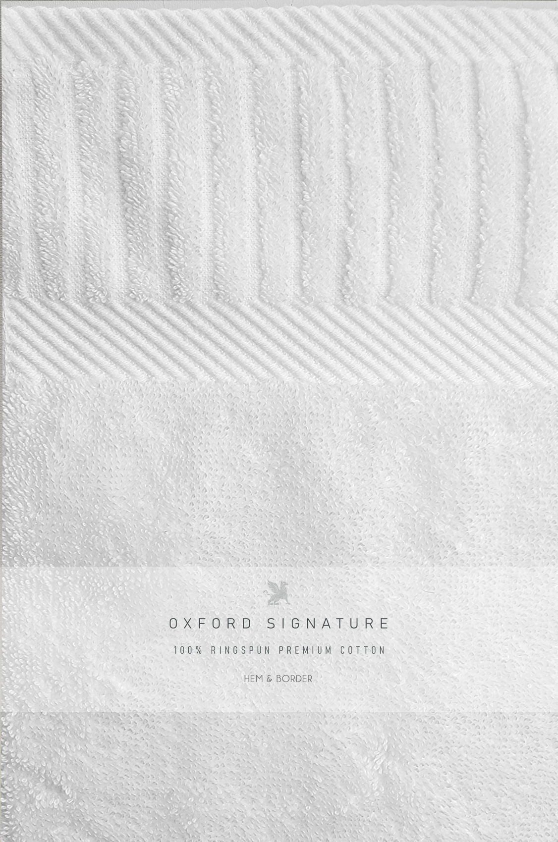 A close-up of the Ganesh Mills Bath Sheet / Pool Towel - White Oxford Signature Towel, featuring varied textures and the Hem & Border label—crafted from 100% ringspun premium cotton for a true luxury hotel experience.