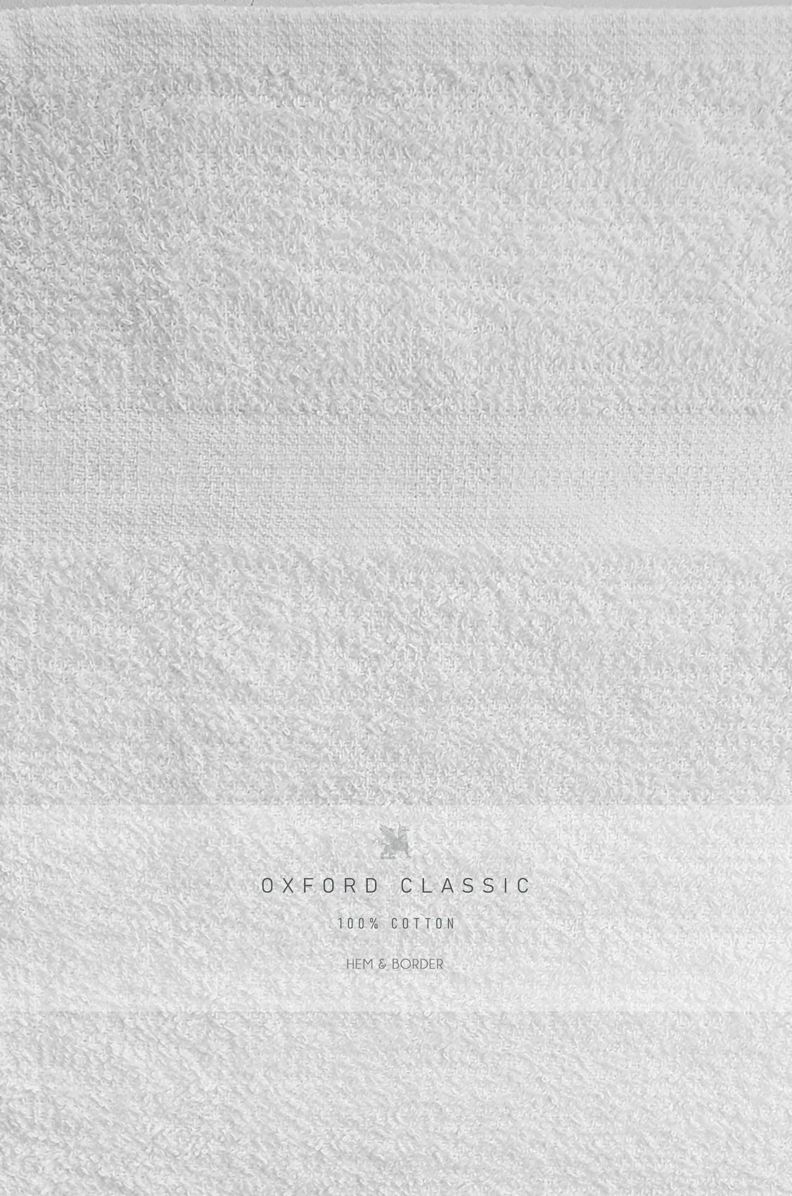 A close-up of the Ganesh Mills Bath Sheet / Pool Towel – White Oxford Classic Bronze, 100% cotton with a subtle striped border—perfect for those seeking premium wholesale towels.