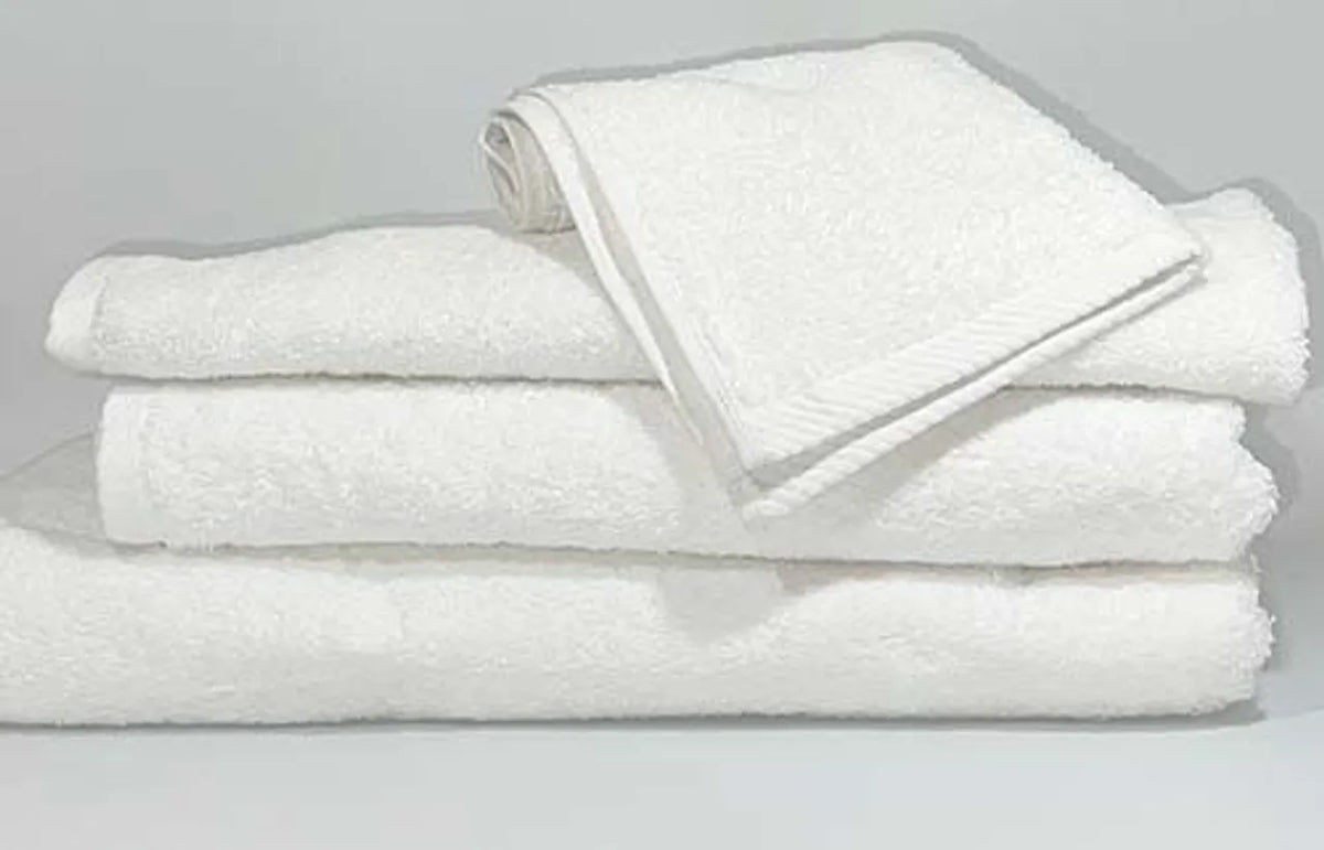 A neatly folded stack includes three large towels topped with the Ganesh Mills Hand Towel - White Oxford Platinum, all set against a plain light background.