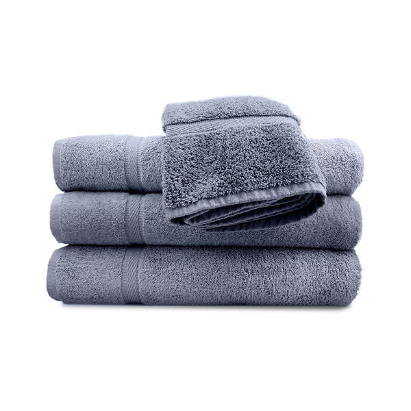 A neatly folded stack of three gray bath towels topped with a Ganesh Mills Hand Towel - Oxford Imperiale Color Towel, set against a white background.
