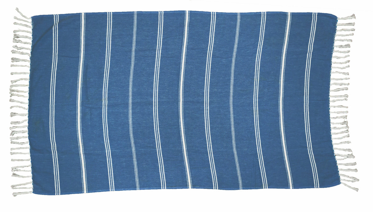 The Pro Towels Peshtemal Beach Towel features a blue rectangular design with white vertical stripes and fringed short edges, crafted from soft Turkish cotton for comfort and style, shown laid flat on a white background.