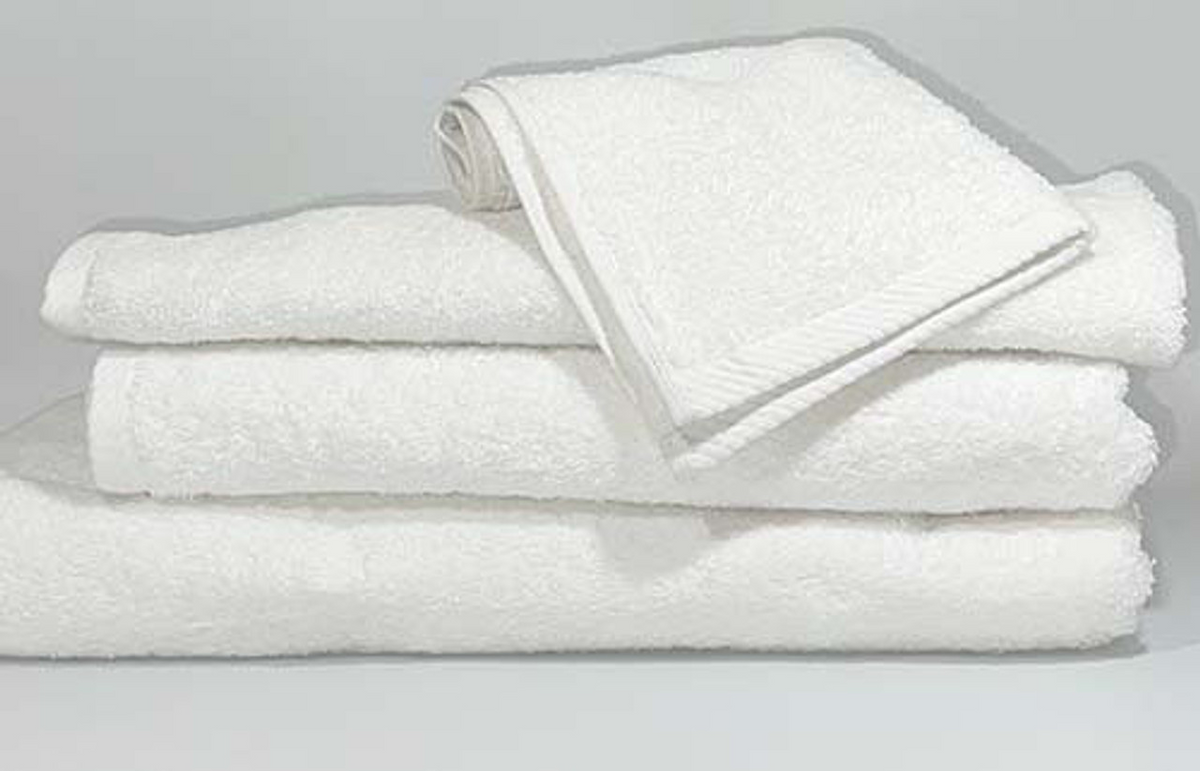 A neatly folded stack from Ganesh Mills’ Oxford Platinum Collection features three large white towels topped with a Washcloth - White Oxford Platinum Towel, all arranged on a flat surface against a plain, light background.