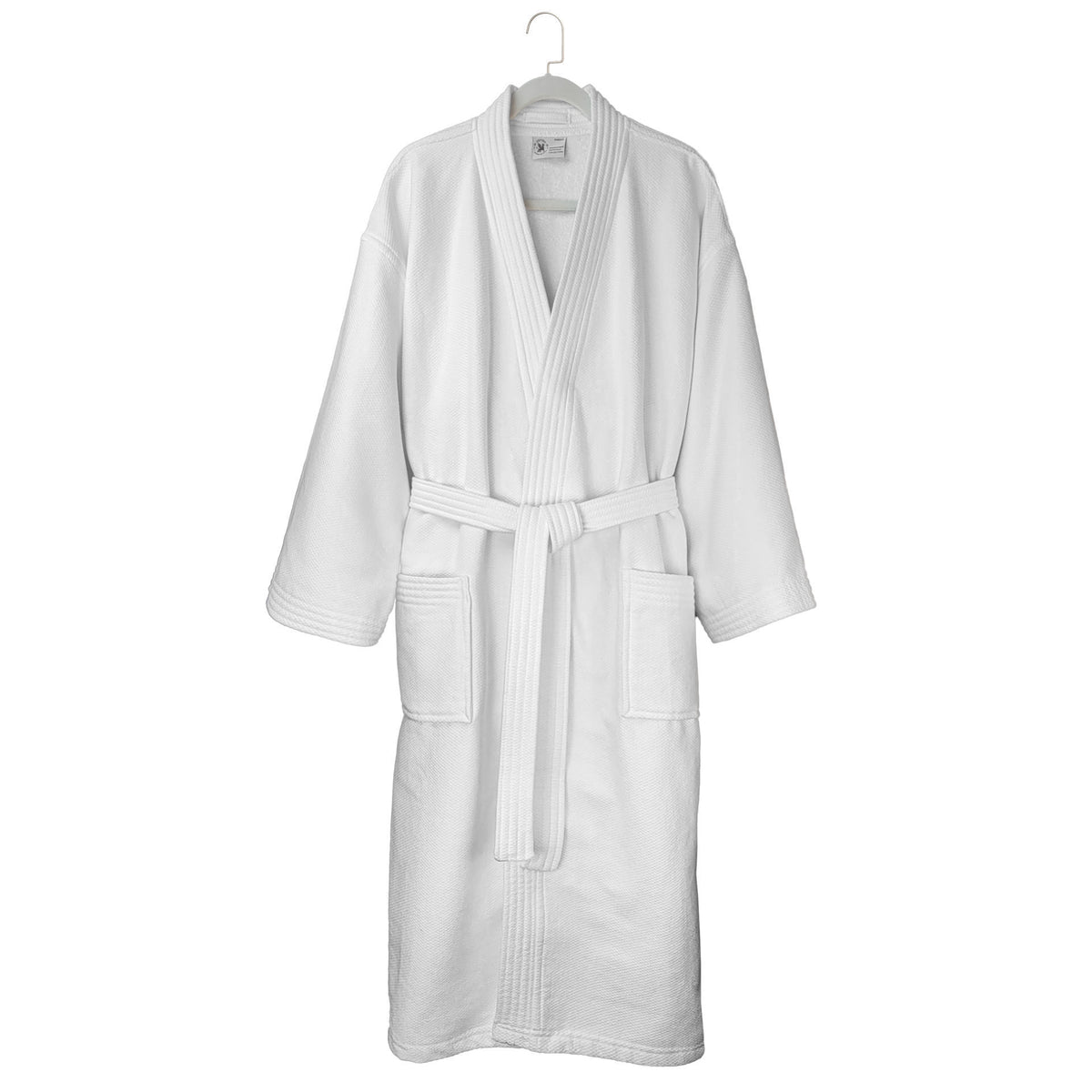 The Ganesh Mills Oxford Double Gauze Bathrobe in white with white piping features long sleeves, two front pockets, and a matching belt, hanging on a white hanger against a plain background.