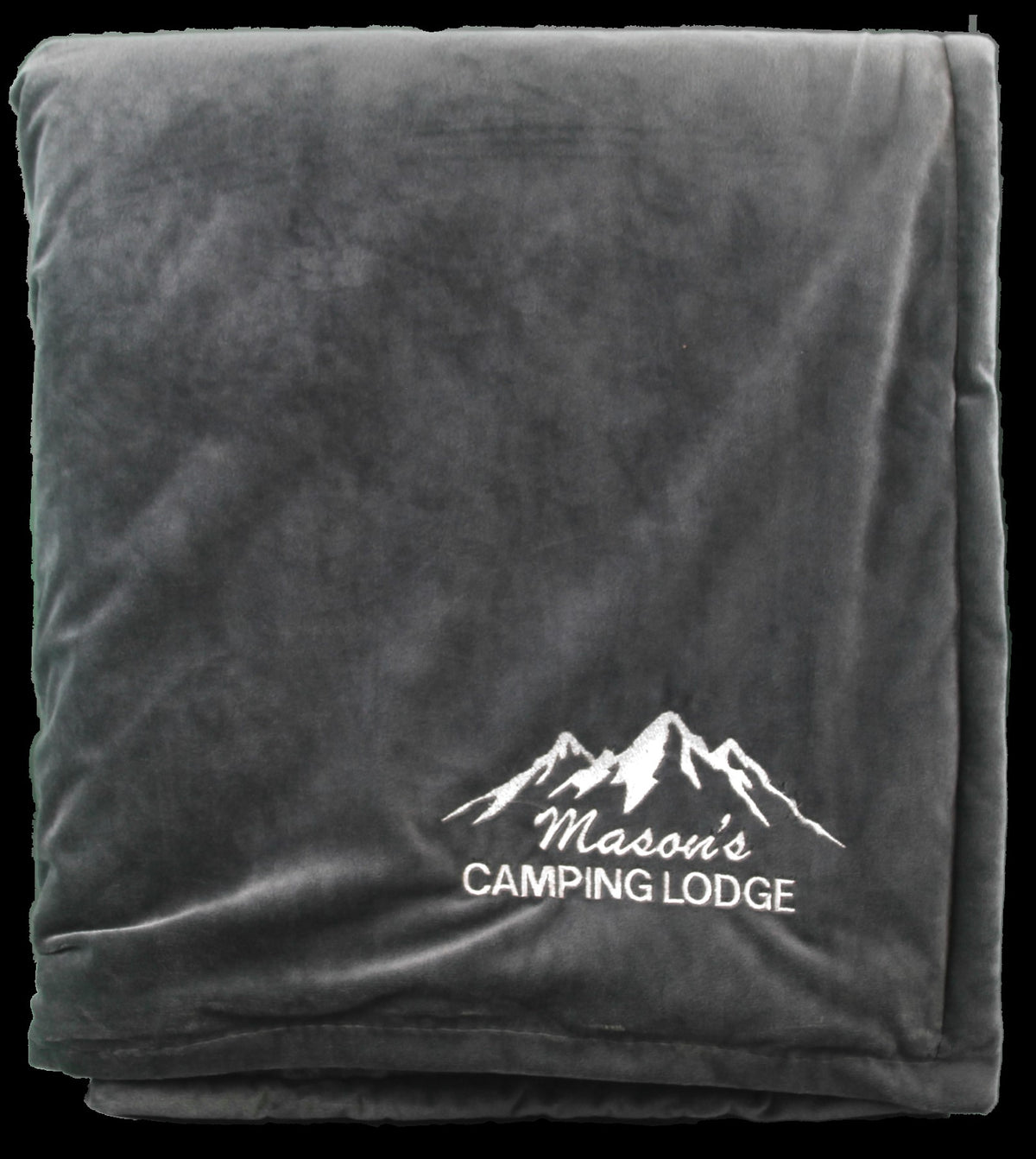 A folded dark gray Rural Llama Throw by Pro Towels, custom embroidered with white stitching reading Masons CAMPING LODGE under three mountain peaks—perfect for cozying up in Sherpa-style comfort.
