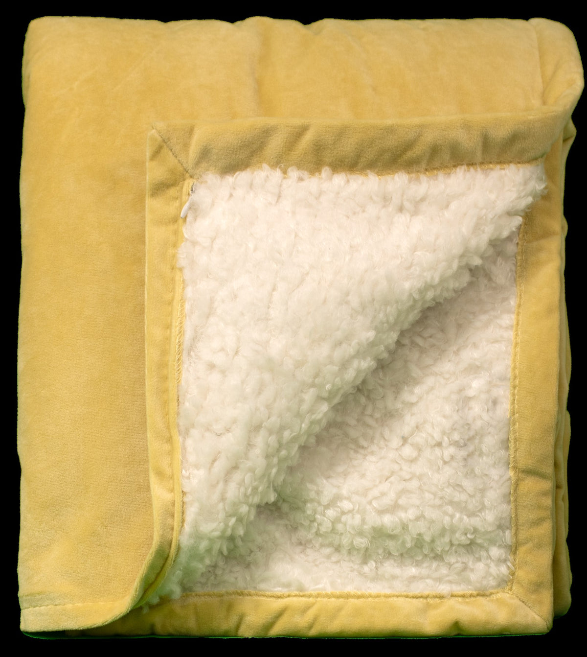 The Pro Towels Rural Llama Throw is a soft, yellow Sherpa-style blanket with a folded corner that reveals its cozy white sherpa lining.