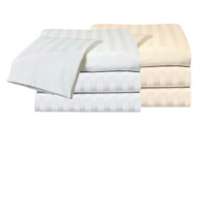 A stack of KSE Royal MicroLux Tone on Tone fitted sheets in white and beige is shown, with a partially unfolded white sheet on top. All sheets feature a subtle striped pattern.