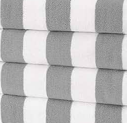 A neatly folded stack of four Ganesh Mills Oxford Playa 2x2 Cabana Pool Towels features wide horizontal light gray and white stripes, shown close up.