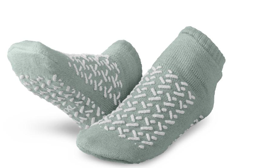 KSE Double-Tread Slipper Socks in light green with white rubber grips are shown on a white background, ideal as non-slip hospital socks.