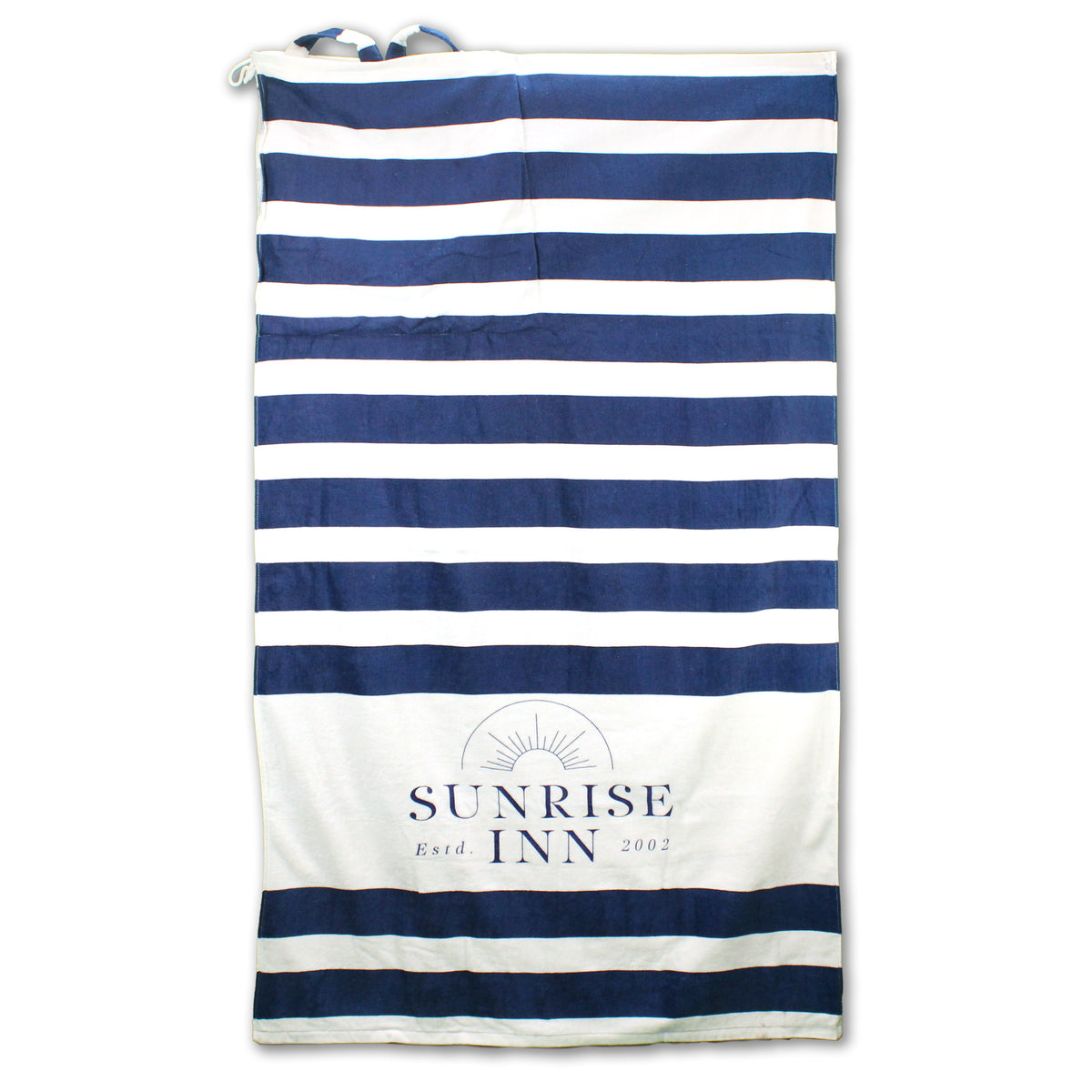 The Shore Buddy - Striped Cabana Beach Towel by Pro Towels features horizontal navy blue and white stripes, SUNRISE INN Estd. 2002 with a sun graphic at the bottom, is made of cotton, and includes a handy tie in the upper left corner.