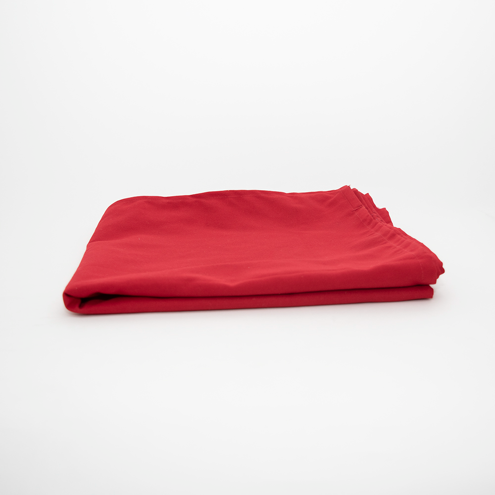 The Prisma Table Cloth RFID Chip by Calderon Textiles, recognized for its colorfast red fabric, is neatly folded and displayed on a plain white surface with a simple, uncluttered background.