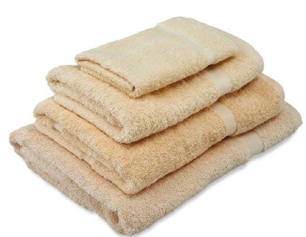 A neatly stacked set of four Thomaston Cam Towels by Thomaston Mills in beige cotton, arranged from largest at the bottom to smallest on top, displayed against a white background.