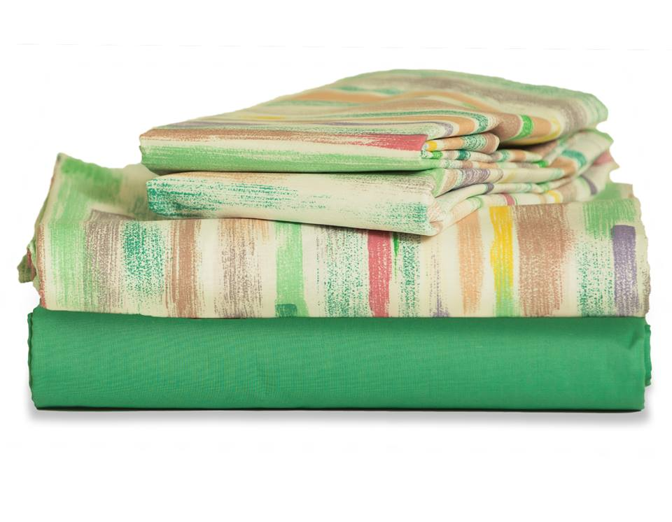 A neatly folded stack of Thomaston Mills Healthcare Items - T-180 Jade Green sheets, with a solid jade green bottom sheet and top sheets in pastel stripes of green, yellow, red, and beige tones.