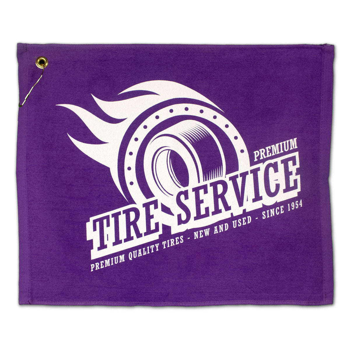 The Jewel Collection Soft Touch Golf Towel by Pro Towels features a purple flag with a white flaming tire graphic and "Premium Tire Service - Premium Quality Tires - New and Used - Since 1954," plus a gold grommet in the top left corner.