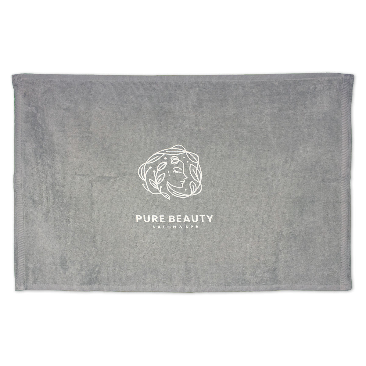 The Pro Towels Diamond Collection Sport Towel in gray features a white minimalist line drawing of a woman's face with flowing hair and "PURE BEAUTY SALON & SPA" below, ideal for custom embroidery.