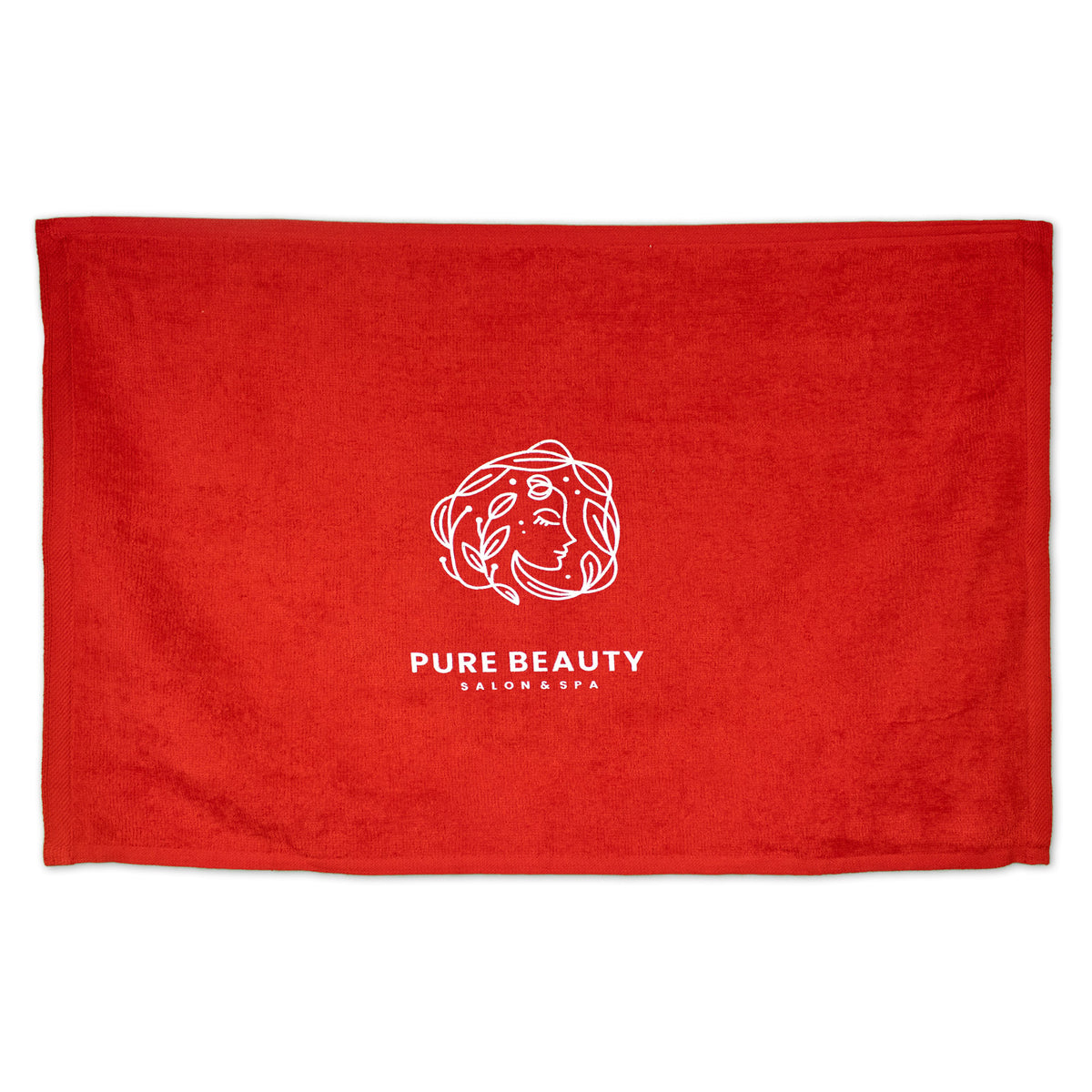 The Diamond Collection Sport Towel by Pro Towels is a red rally towel with custom embroidery: a white line art logo of a woman's face with leaves and "PURE BEAUTY SALON & SPA" centered below.