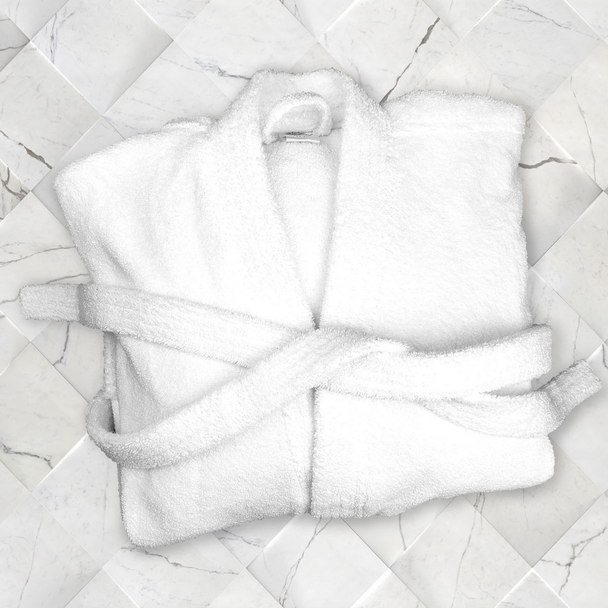 A White Replacement Belt for Oxford Double Sided Bathrobes by Ganesh Mills is displayed folded on a white marble tiled surface.