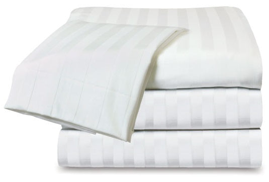 A neatly folded stack of KSE Royal MicroLux Tone on Tone white bedsheets with subtle stripes, paired with a crisp matching pillowcase, with one sheet partially unfolded and draped over the top.
