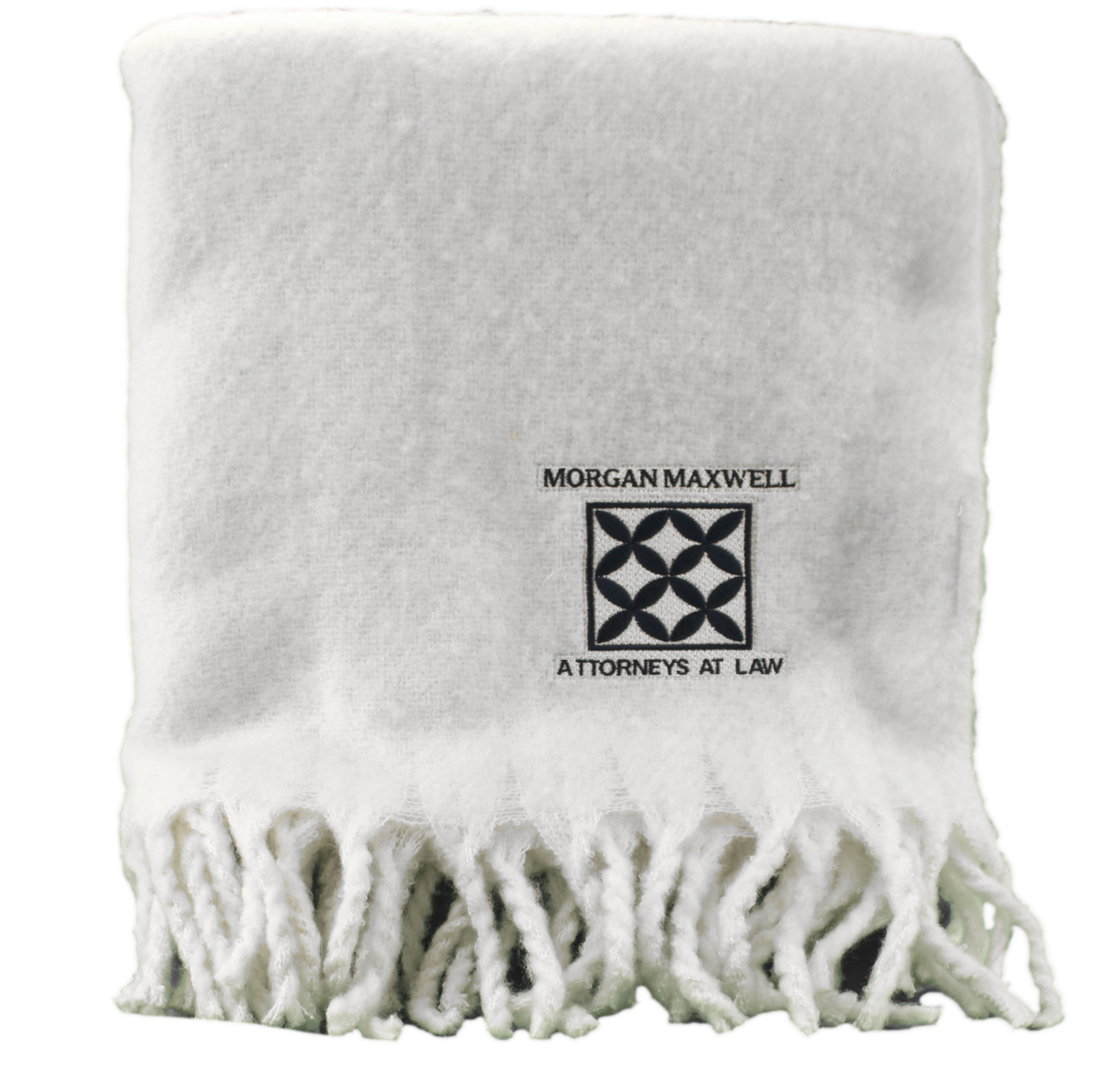A folded white Pro Towels Vanilla Dream Throw with fringed edges, custom embroidered with the Morgan Maxwell Attorneys at Law logo on the front.