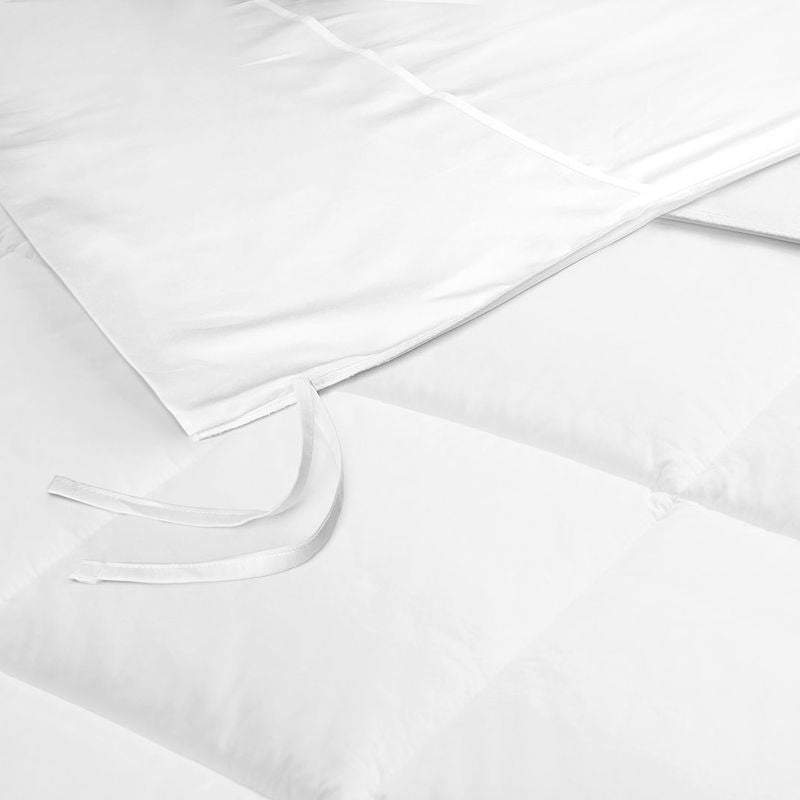 Close-up of Ganesh Mills Light Weight Duvet Inserts - T210 Fabric with Micro Gel Fiber, showing soft, quilted textiles and corner ties to secure the insert inside the cover for comfort.