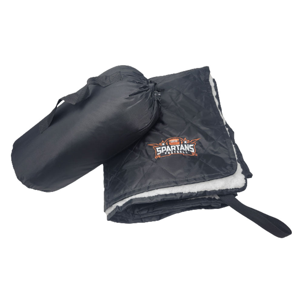 A black, rolled-up Waterproof Sherpa Blanket by Pro Towels with a carrying handle sits beside an unfolded version featuring custom Spartans Football embroidery and a soft white lining.