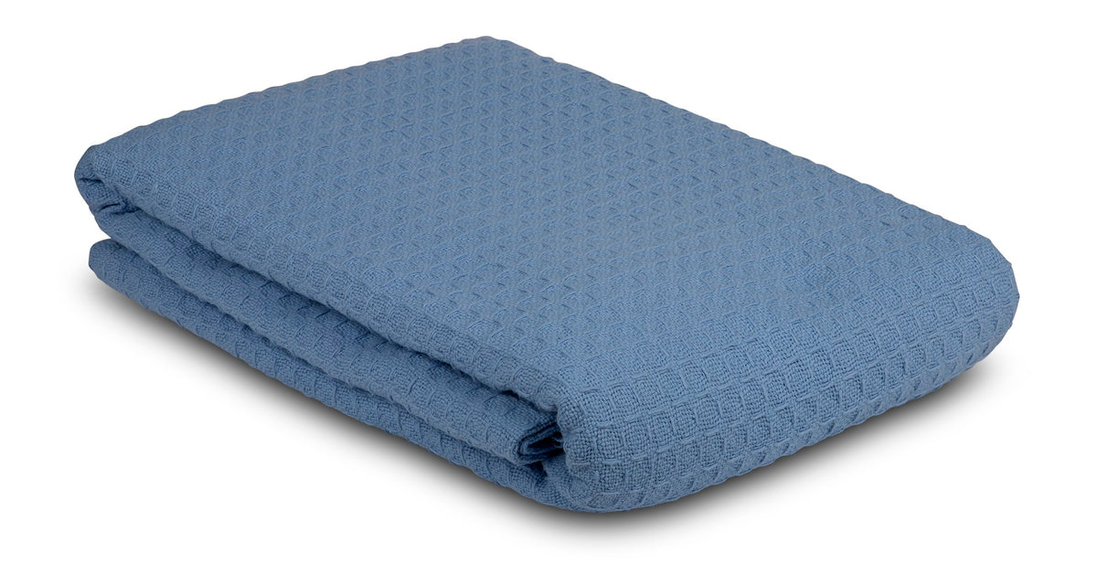 The KSE Waffle Weave Blankets feature a folded blue cotton design with a textured diamond pattern, perfect for adding style to your home or for businesses seeking wholesale blankets.