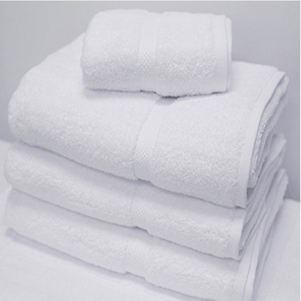 A neatly folded stack of 1Concier Bath Sheets (70% cotton/30% poly) features one small towel atop three larger towels, all secured with white bands, set against a plain white background.