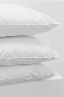 Three white 1Concier Pillow Down Alt Pillows are stacked neatly on top of each other against a plain white background.