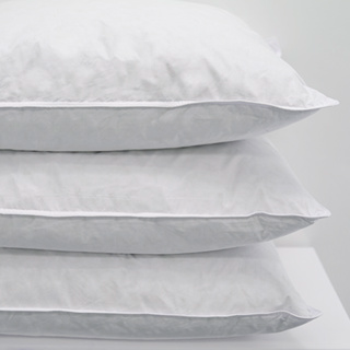 Three Pillow Soft & Downey Natural Pillows by 1Concier are stacked neatly against a light background, highlighting their soft, plush texture and clean appearance.