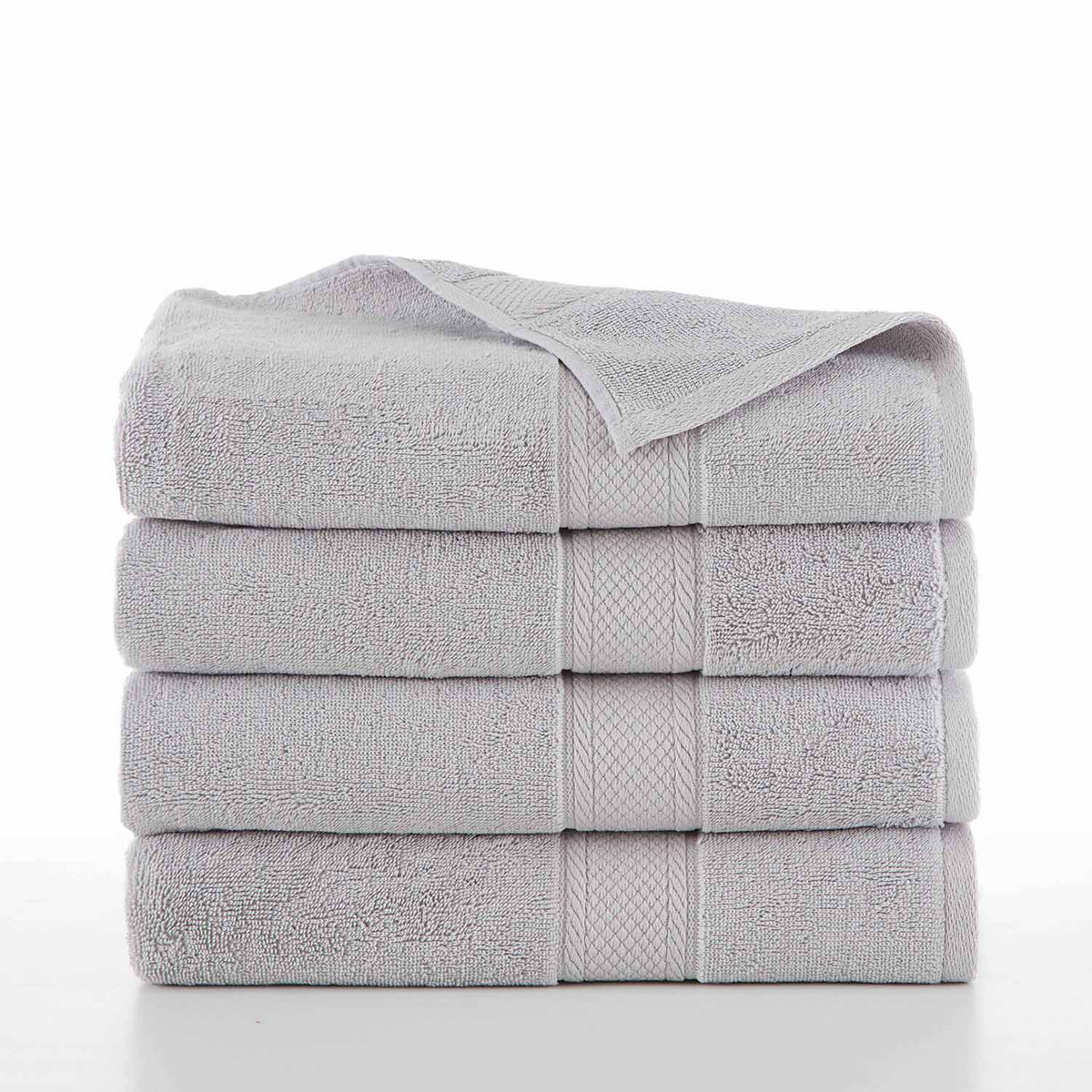 A neatly folded stack of four light gray WestPoint Home Dobby Towel - Grand Patrician Suites towels is shown on a white surface. The thick, ring-spun cotton towels feature a subtle textured border against a plain white background.