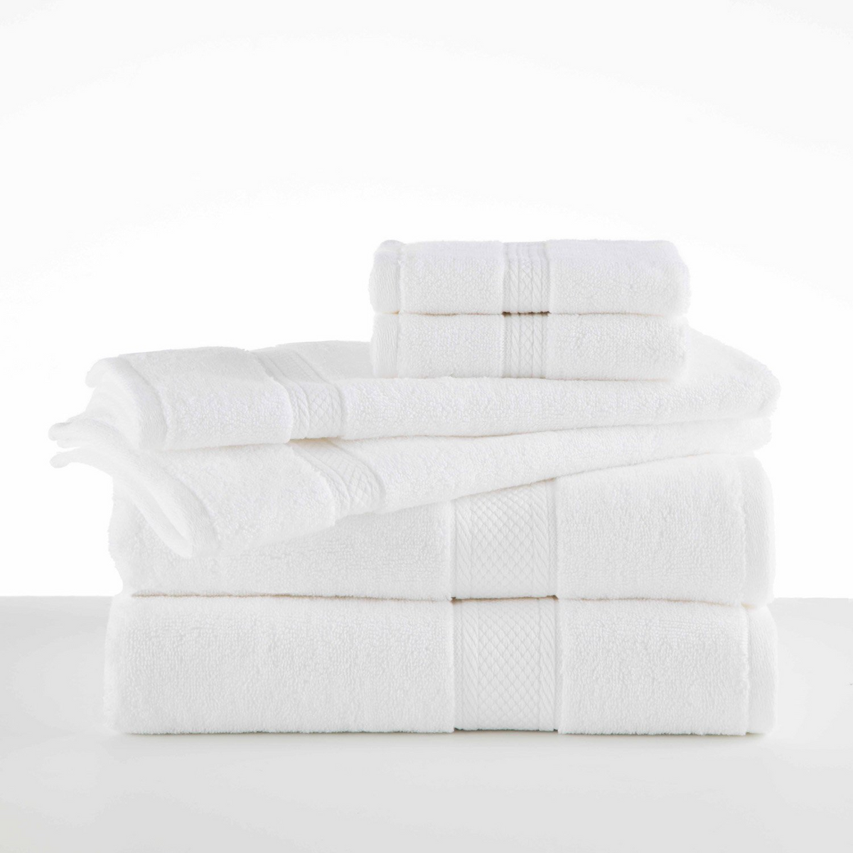 A neatly stacked set of WestPoint Home Grand Patrician Suites Dobby Towels—bath towels, hand towels, and washcloths—are arranged on a white surface with a clean, minimalist background.