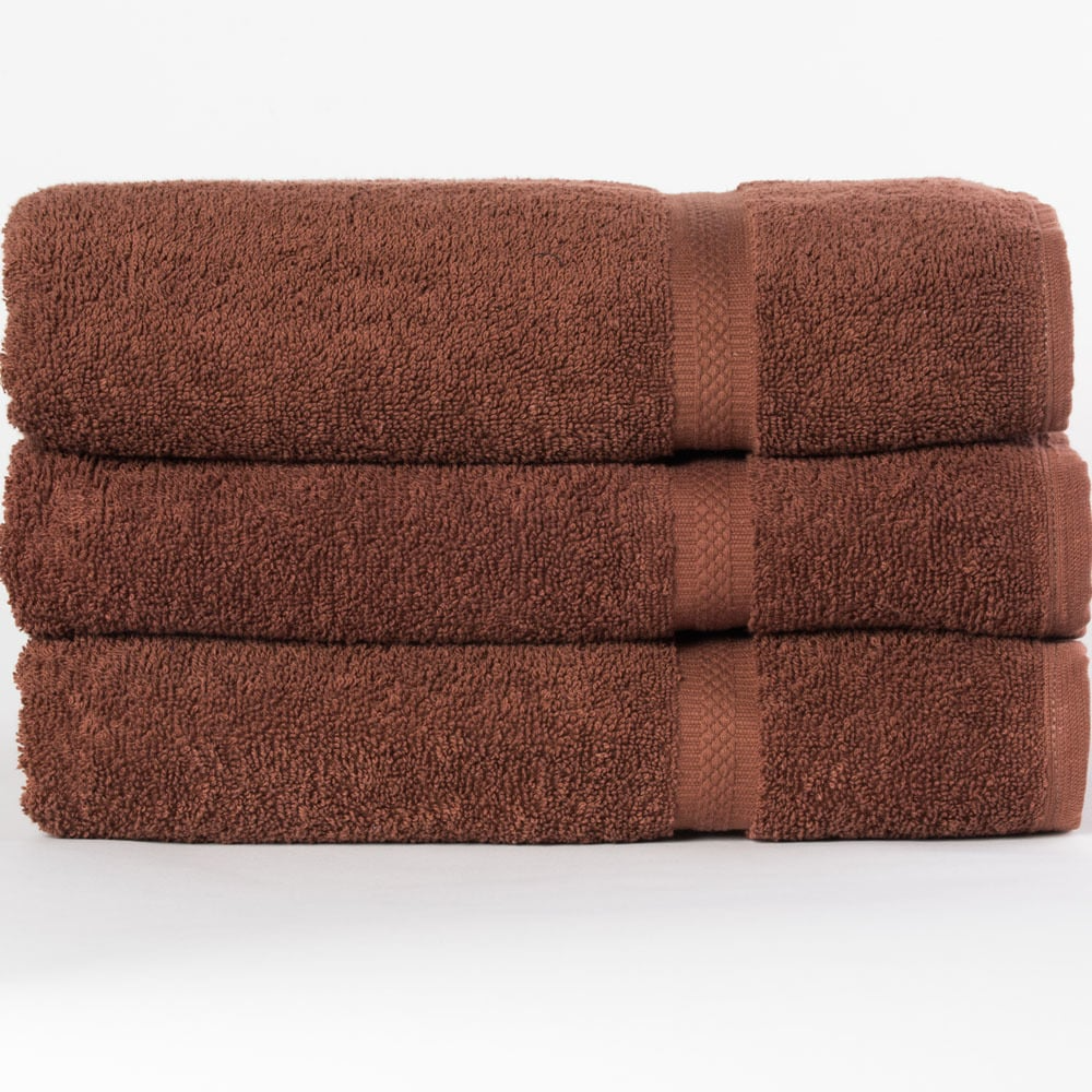 Three neatly folded brown WestPoint Home Dobby Towel - Martex Colors towels stacked atop each other against a plain white background.