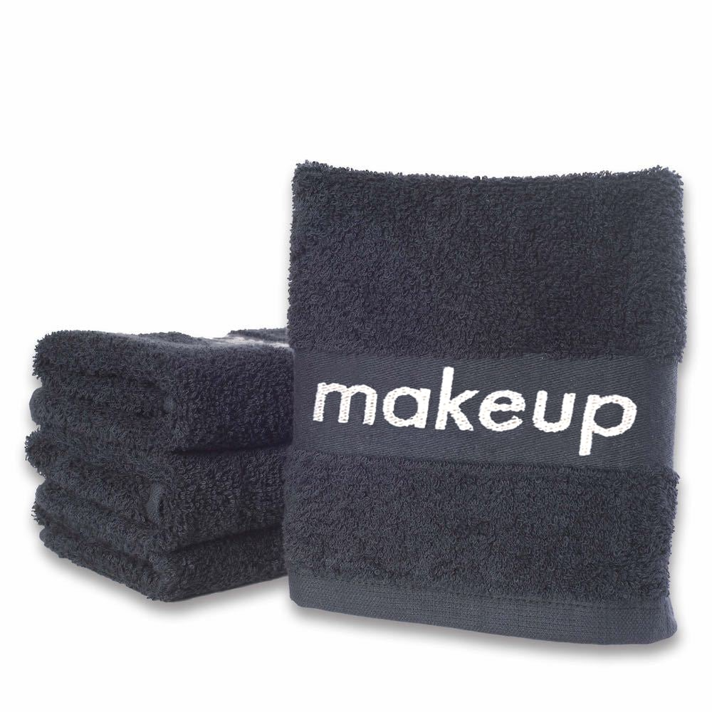 The WestPoint Home Makeup Removal Wash Cloth - Martex Spa is a stack of black towels featuring fade-resistant technology and a front towel labeled makeup in white, ensuring lasting vibrancy after frequent washes.