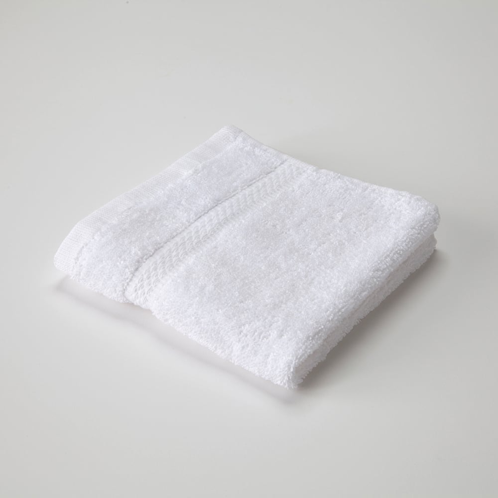 The WestPoint Home Dobby Towel - Martex Brentwood, crafted from 100% cotton with a textured dobby pattern, rests on a light surface, showcasing its luxury absorbency and refined elegance.