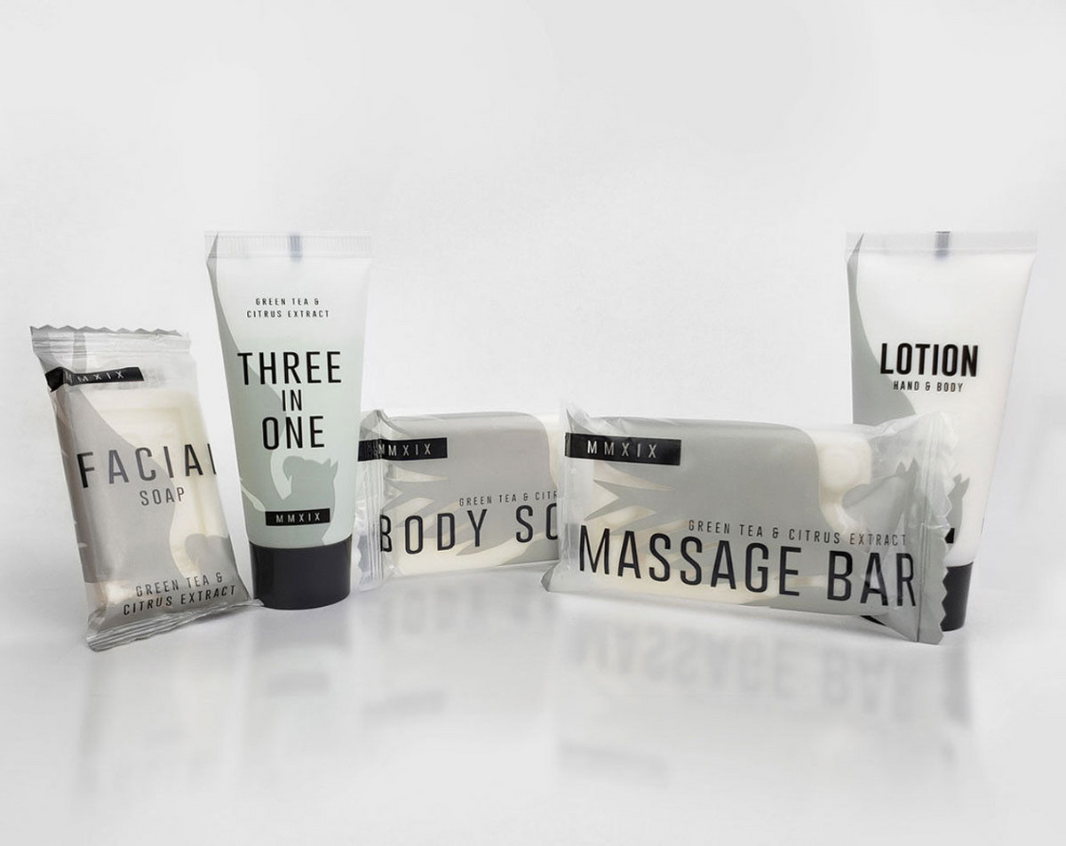 A set of five premium Ganesh Mills hotel amenities, featuring Soap (Rectangle Shape) - Candy Wrap Embossed, all labeled with green tea & citrus extract—ideal as luxury body care products for hotels.