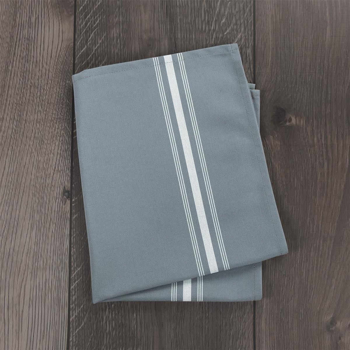 A folded gray 1Concier Premier Bistro Napkin with two parallel white stripes rests on a dark wooden surface.
