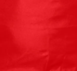 A close-up view of the bright red, slightly wrinkled polyester surface of the Industrial Mesh Open Top from Bulk Linen Supply.